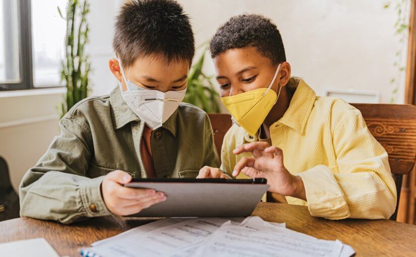 Children Wearing Face Masks Looking at the Screen of Tablet