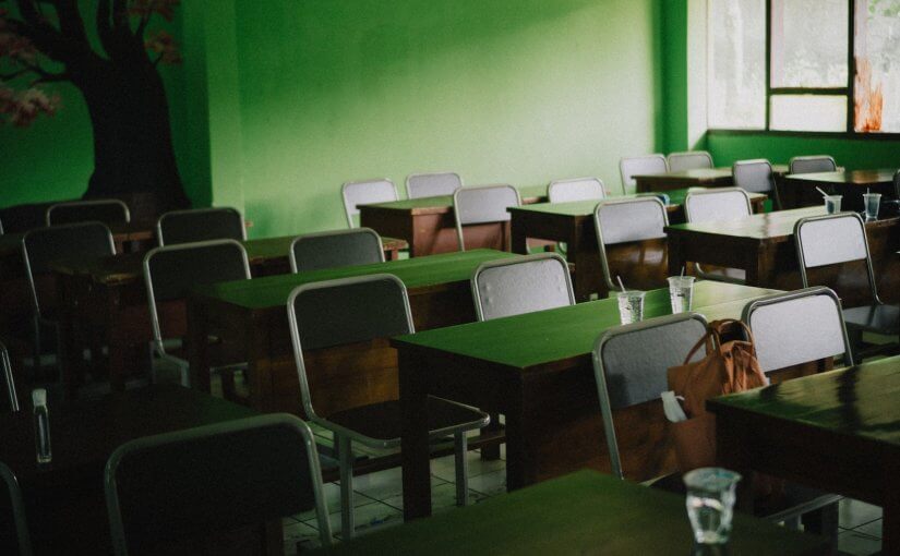 green and white chairs near green wall
